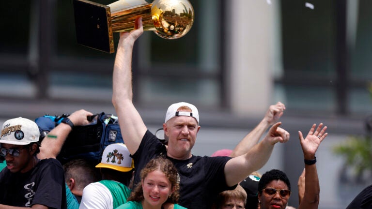 Former Boston Celtic Brian Scalabrine holds the Larry O’Brien championship trophy from the 2008 NBA Finals during a duck boat parade to celebrate the 18th Boston Celtics NBA championship on Friday, June 21, 2024. The Celtics defeated the Dallas Mavericks in Game 5 of the NBA Finals.
