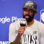 Dallas Mavericks guard Kyrie Irving answers questions during a news conference after the team's win over the Minnesota Timberwolves in Game 5 of the NBA basketball Western Conference finals Thursday, May 30, 2024, in Minneapolis.