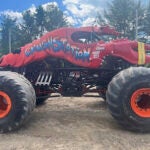 This photo provided by the Topsham Police Department shows a lobster-themed monster truck that clipped an aerial power line, toppling several utility poles while performing for a crowd at the Topsham Fairgrounds on Saturday, June 1, 2024.