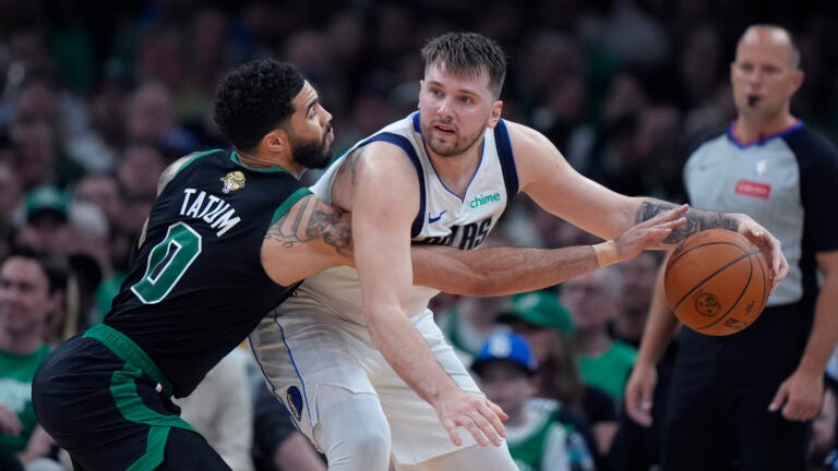 Celtics forward Jayson Tatum pressures Dallas Mavericks guard Luka Doncic during the first half of Game 2 of the NBA Finals.
