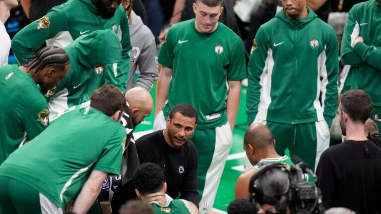 Celtics head coach Joe Mazzulla, center, speaks to his players during a timeout in the first half of Game 5 of the NBA Finals against the Dallas Mavericks.