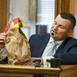 Massachusetts State Police trooper Yuriy Bukhenik, holding an evidence bag, testifies during Karen Read's trial, Thursday, June 6, 2024, at Norfolk Superior Court in Dedham.