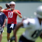 New England Patriots quarterback Drake Maye (10) winds up to pass during an NFL football practice, Tuesday, June 4, 2024, in Foxborough, Mass.