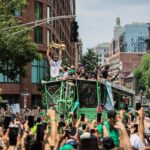 BOSTON, MA - 6/21/2024 Boston Celtics forward Jayson Tatum (0) holds up the Larry O'Brien Championship Trophy during a duck boat parade to celebrate the 18th Boston Celtics NBA championship on Friday, June 21, 2024. The Celtics defeated the Dallas Mavericks in Game 5 of the NBA Finals.