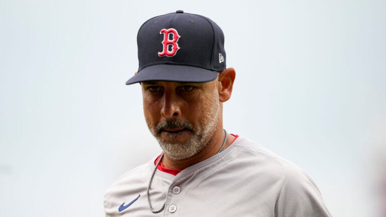 Boston Red Sox manager Alex Cora jogs to the dugout after a pitching change in the fourth inning of a baseball game against the Cincinnati Reds in Cincinnati, Sunday, June 23, 2024.