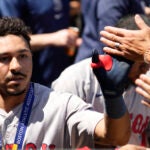 David Hamilton celebrates with his Red Sox teammates after hitting a solo home run during the fifth inning.