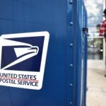 A United States Postal Service logo is displayed on a U.S. Post Office mailbox on April 1, 2024