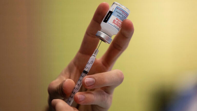 A dose of a Moderna COVID-19 vaccine is prepared.