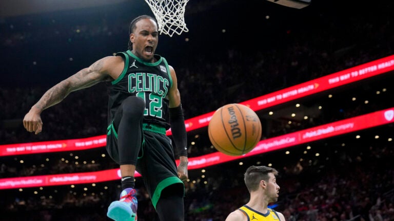 Boston Celtics forward Oshae Brissett (12) celebrates after dunking against the Indiana Pacers during the second half of Game 2 of the NBA Eastern Conference basketball finals Thursday, May 23, 2024, in Boston.