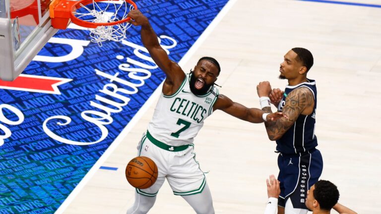 Celtics guard Jaylen Brown (7) slam dunks past Dallas Mavericks forward P.J. Washington (25) during the third quarter in Game 3 of the NBA Finals.