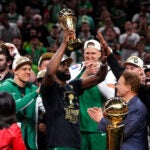 Boston Celtics guard Jaylen Brown (7) hoists the MVP trophy after Game 5 of the NBA Finals. The Boston Celtics hosted the Dallas Mavericks at TD Garden on Monday, June 17, 2024.