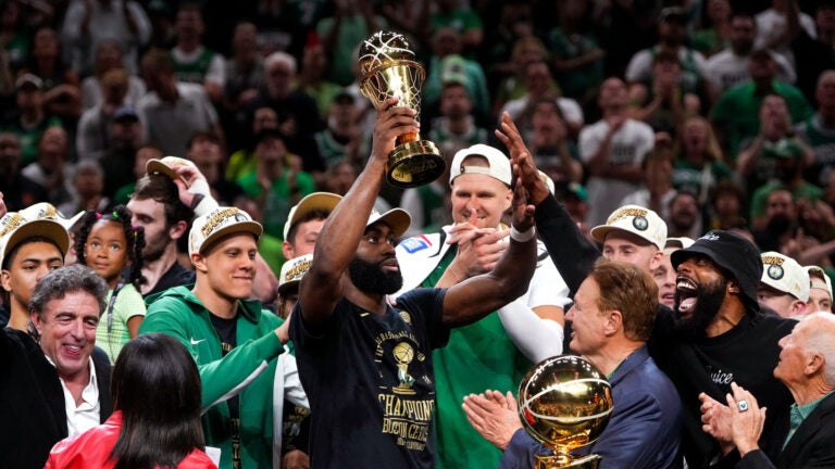 Boston Celtics guard Jaylen Brown (7) hoists the MVP trophy after Game 5 of the NBA Finals. The Boston Celtics hosted the Dallas Mavericks at TD Garden on Monday, June 17, 2024.