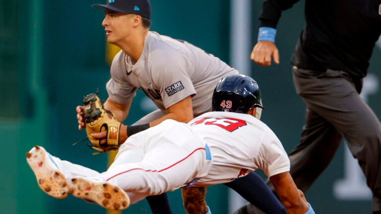 Red Sox Ceddanne Rafaela steals second base as New York Yankees shortstop Anthony Volpe waits for the throw during second inning.