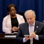 City Clerk Alex Geourntas tallies the Boston City Council’s vote on Mayor Michelle Wu’s property-tax policy earlier this month. Council president Ruthzee Louijeune is at left.
