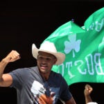 Celtics Al Horford, wearing a cowboy hat and Tom Brady shirt, celebrates on a duck boat parade.