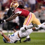 San Francisco 49ers wide receiver Brandon Aiyuk, top, catches a pass against Detroit Lions cornerback Kindle Vildor (29) during the second half of the NFC Championship NFL football game in Santa Clara, Calif.