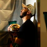 Boston Celtics forward Jayson Tatum holds the Larry O'Brien championship trophy in the locker room after winning the 2024 NBA Finals over the Dallas Mavericks at TD Garden on Monday, June 17, 2024.