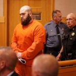 Joseph Eaton, left, enters Sagadahoc County Superior Court in West Bath, Maine.