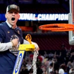 UConn head coach Dan Hurley celebrates cutting the net after their win against Purdue in the NCAA college Final Four championship basketball game.