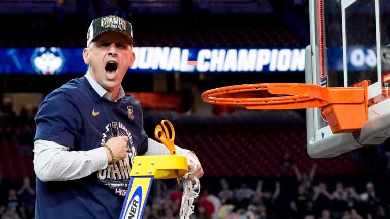 UConn head coach Dan Hurley celebrates cutting the net after their win against Purdue in the NCAA college Final Four championship basketball game.