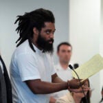 Jamhal Tavon Sanders Latimer, center, reads an allocution to the judge while standing near defense attorney Daniel Thompson, left, during a sentencing hearing.