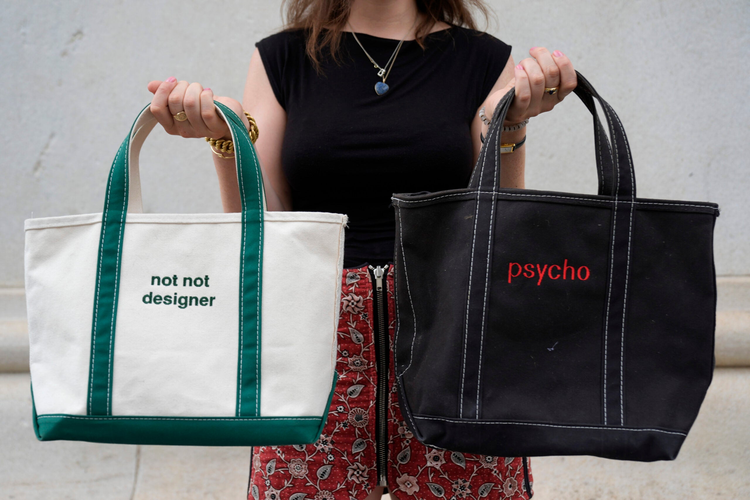 Gracie Wiener poses with some of her tote bags in Washington Square Park in New York.