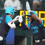 National League's Shohei Ohtani, of the Los Angeles Dodgers, left, celebrates his three-run home with Jurickson Profar, of the San Diego Padres, in the third inning during the MLB All-Star baseball game in Texas.