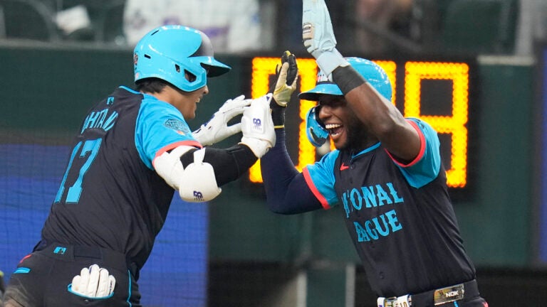 National League's Shohei Ohtani, of the Los Angeles Dodgers, left, celebrates his three-run home with Jurickson Profar, of the San Diego Padres, in the third inning during the MLB All-Star baseball game in Texas.