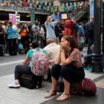 A traveler waits inside the Gare du Nord train station at the 2024 Summer Olympics in Paris, France.