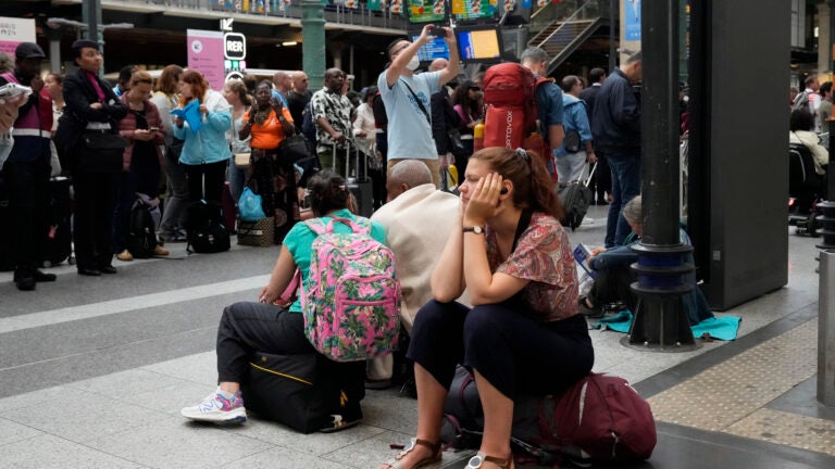 A traveler waits inside the Gare du Nord train station at the 2024 Summer Olympics in Paris, France.