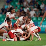 Canada's players celebrate after Vanessa Gille, bottom center, scored her side's second goal during the women's Group A soccer match between Canada and France at Geoffroy-Guichard stadium during the 2024 Summer Olympics.