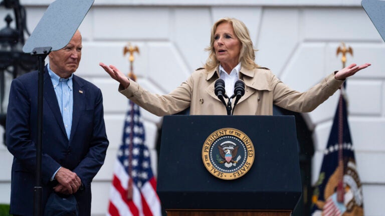 President Joe Biden listens as first lady Jill Biden speaks during a barbecue with active-duty military service members and their families on the South Lawn of the White House, Thursday, July 4, 2024, in Washington.