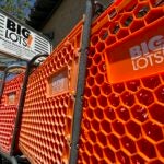 The Big Lots logo is displayed on shopping carts in front of a Big Lots store.