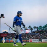 Toronto Blue Jays' Bo Bichette walks to the dugout after striking out against the San Francisco Giants during the sixth inning of a baseball game.
