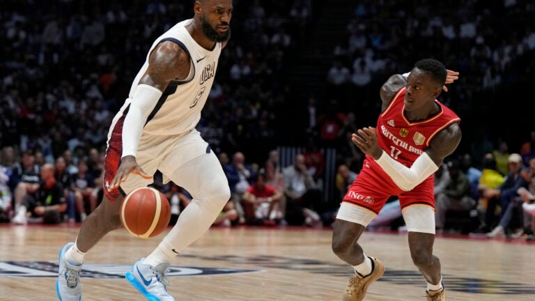 United States' forward LeBron James, left, and Germany's guard Dennis Schroeder challenge for the ball during an exhibition basketball game between the United States and Germany at the O2 Arena in London.