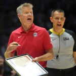 United States' head coach Steve Kerr gestures to his players during an exhibition basketball game between the United States and South Sudan, at the o2 Arena in London.