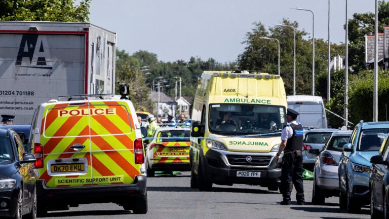 Emergency services work at the scene in Southport, England, where a man has been detained and a knife has been seized after a number of people were injured in a reported stabbing, Monday July 29, 2024.