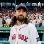 Noah Kahan stands on the field at Fenway Park before throwing the ceremonial first pitch prior to a baseball game between the Boston Red Sox and the Chicago Cubs.