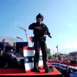 Republican presidential candidate former President Donald Trump is surrounded by U.S. Secret Service agents on stage at a campaign rally, Saturday, July 13, 2024, in Butler, Pa.