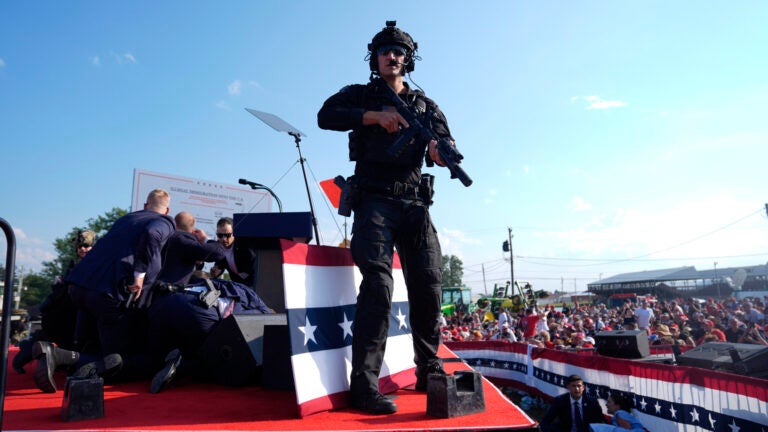 Republican presidential candidate former President Donald Trump is surrounded by U.S. Secret Service agents on stage at a campaign rally, Saturday, July 13, 2024, in Butler, Pa.