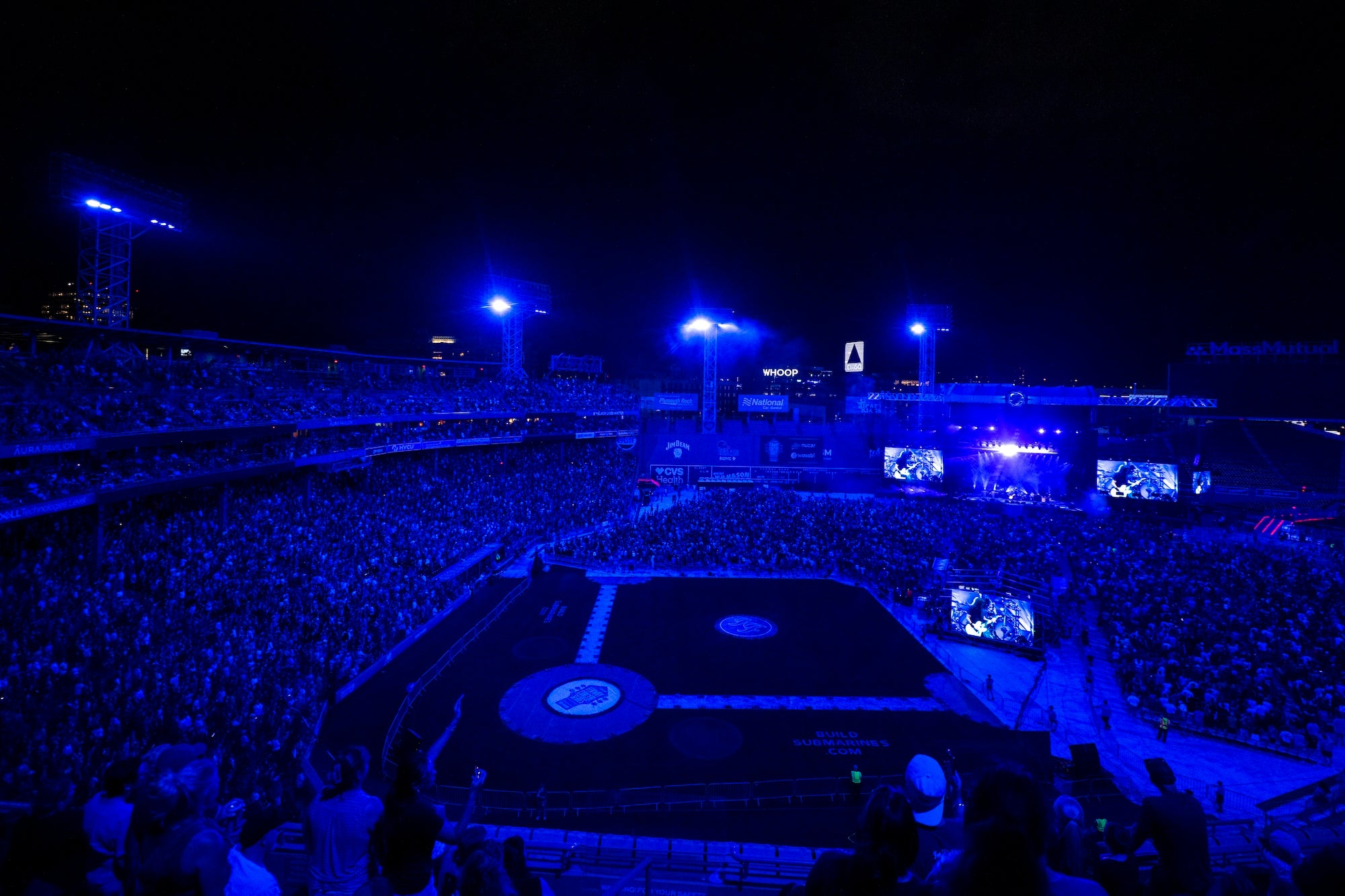 The crowd at Fenway Park is bathed in blue light during the Foo Fighters concert on July 21, 2024.