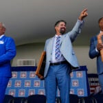 Baseball Hall of Fame inductees Jim Leyland, left, Todd Helton, center, and Adrián Beltré, right, holds their plaques at the National Baseball Hall of Fame induction ceremony.