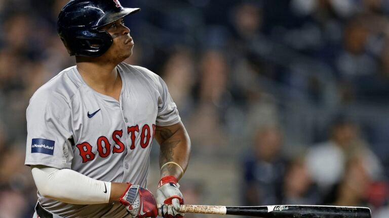 NEW YORK, NEW YORK - JULY 07: Rafael Devers #11 of the Boston Red Sox hits a solo home run in the ninth inning against the New York Yankees at Yankee Stadium on July 7, 2024 in New York City. The Red Sox won 3-0.