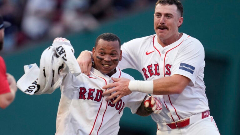 Rafael Devers of the Red Sox celebrates after his game-winning RBI double, which drove in Tyler O'Neill, during the 10th inning.