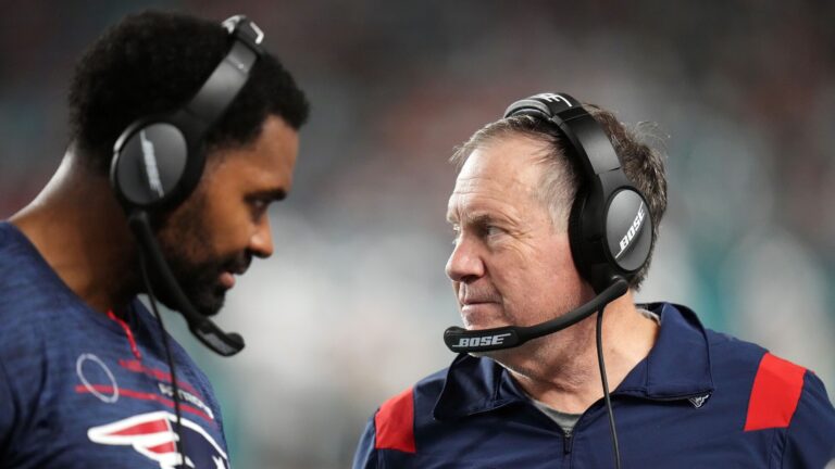 Jerod Mayo and Bill Belichick talk on the sidelines during a game against the Miami Dolphins in 2022. Mayo recently took over for Belichick as head coach of the New England Patriots.