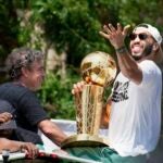 Boston Celtics' Jayson Tatum, right, and Celtics owner Wyc Grousbeck, center, celebrate their NBA basketball championship with a duck boat parade Friday, June 21, 2024, in Boston.