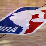 An NBA logo is seen at center court prior to an NBA basketball game between the Los Angeles Clippers and the Los Angeles Lakers.