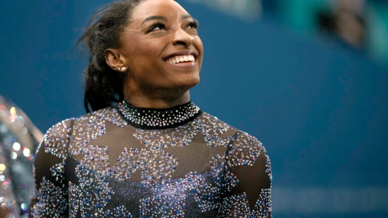 Simone Biles of United States, smiles after competing on the uneven bars during a women's artistic gymnastics qualification round at Bercy Arena at the 2024 Summer Olympics.