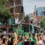 Boston Celtics forward Jayson Tatum (0) holds up the Larry O'Brien Championship Trophy during a duck boat parade to celebrate the 18th Boston Celtics NBA championship.