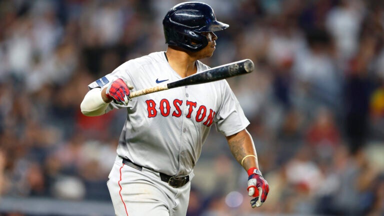 Rafael Devers of the Red Sox tosses his bat after hitting a home run against the New York Yankees during seventh inning.